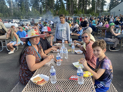 A happy family enjoying a meal during the family BBQ