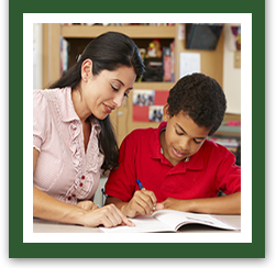 Teacher helping tutor African American boy