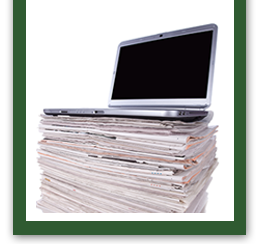 Laptop on a stack of newspapers