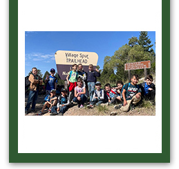 Group of students outside holding up signs